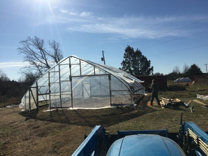 Pulling the plastic over our new greenhouse