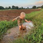 Cooper splashing ina puddle along the field