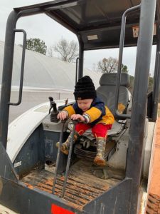 Cooper enjoying Mr Tuckers skid steer