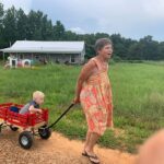 Grammy G pulling Cooper in the wagon
