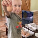 Cooper showing us which way eggs are packed into a carton