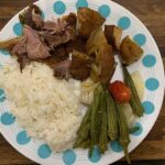 Roasted goat, potatoes, okra, tomatoes with rice