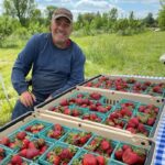 Randy selling strawberries at our pop up farm stand