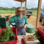 Anna, bunching carrots on a busy harvest day
