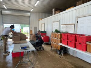 Robin (L) and Randy (R) putting together boxes for the CSA