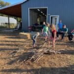 Several children building a wood pile for the bonfire at our Fall party
