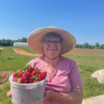 Connie, Randy's mom, with a bucket of fresh picked strawberries