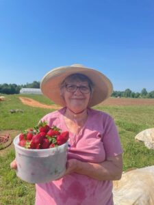 Connie, Randy's mom, with a bucket of fresh picked strawberries