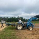 Josephine increasing her skill set. She did all the field prep work shaped beds and here is wrapping them in the Bio360