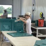 Cooper helping out in wash pack assembling CSA boxes,