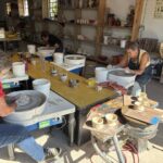 Connie (L) and Guin (R), our moms, having a go at spinning some pottery