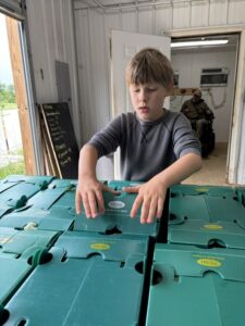 Cooper closing up some CSA boxes