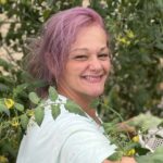 Kayla picking tomatoes