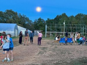 Full moon rising over the farm party festivities