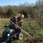 Randy, hacking out brush from the fence line with the Rogue Hoe