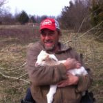 Randy Alexander holding one of our 2016 baby goats.