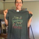 Jo holding up a t-shirt that reads, "I love gardening from my head tomatoes"