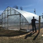 Patrick dtanding in front of ouf new 30 foot by 30 foot greenhouse