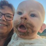 Cooper with mud all on his face, Guin Grammy G holding him